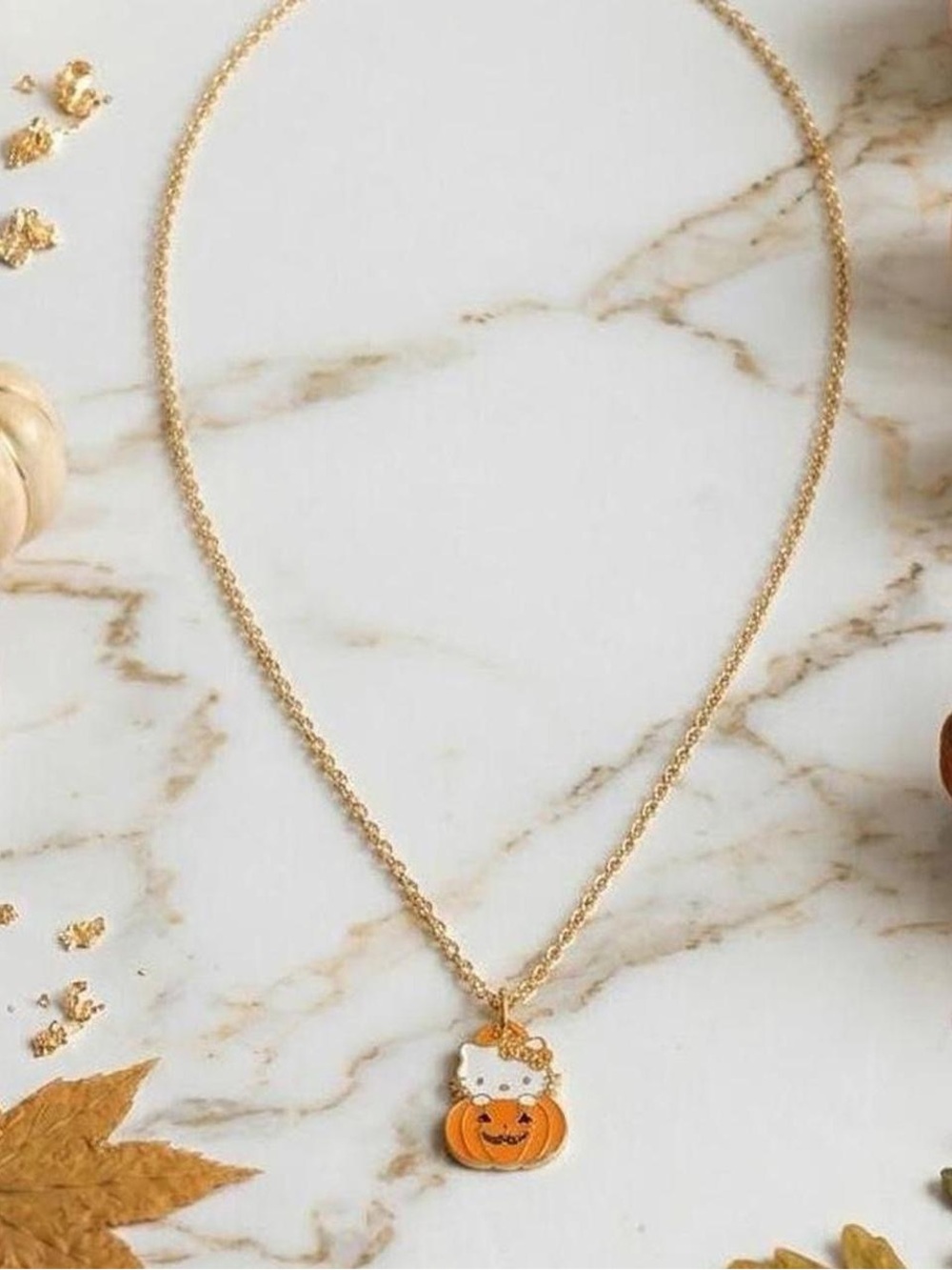 Cute Sanrio hello kitty necklace with a gold tone chain and a black enamel hello